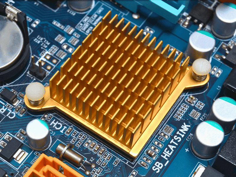Gold anodized aluminum pin-fin heat sink on a blue PCB.