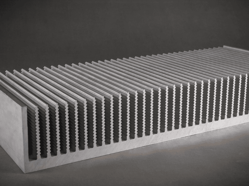 A wide, heavy-duty aluminum profile heat sink featuring serrated vertical fins for increased surface area.