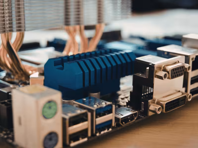 A blue anodized heat sink and copper heat pipes on a circuit board.