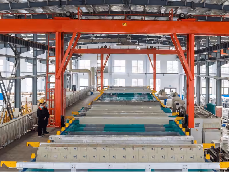 Industrial-scale aluminum profile surface treatment line in the JIUJU facility, showcasing advanced anodizing and finishing capabilities.